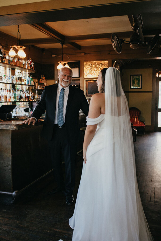 A bride has a first look with her father at her avant garden wedding