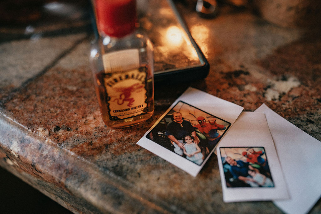 Polaroids of a bride and her father are photographed next to a shot at her avant garden wedding