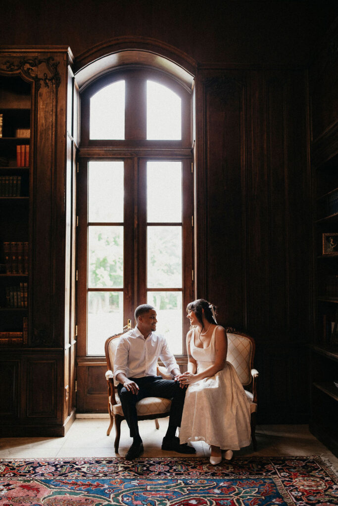 A Houston TX couple is photographed in the mahogany room at a chateau wedding venue houston tx for their engagement session