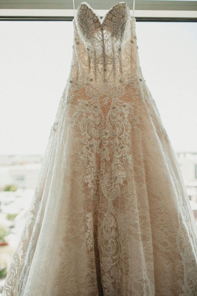 A lace wedding gown is photographed at a texas hill country elopement