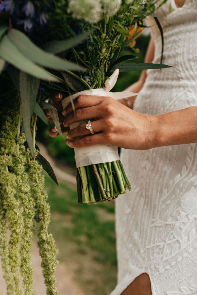 A bride's ring and bouquet are photographed at Pecan Springs Ranch Austin, TX