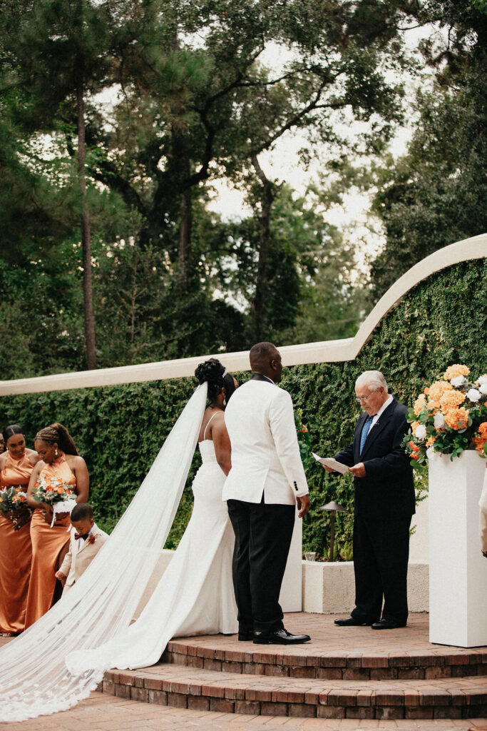 A couple exchanges vows during their wedding at the spring event venue cypress