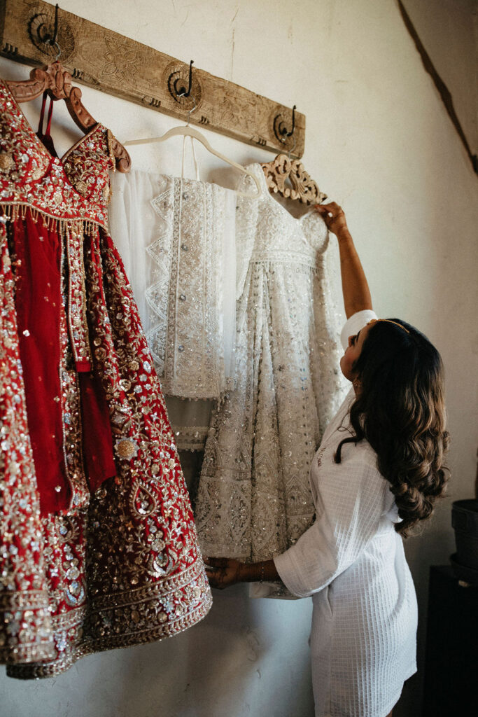 a bride admires her dress at her Three Bells Mission wedding