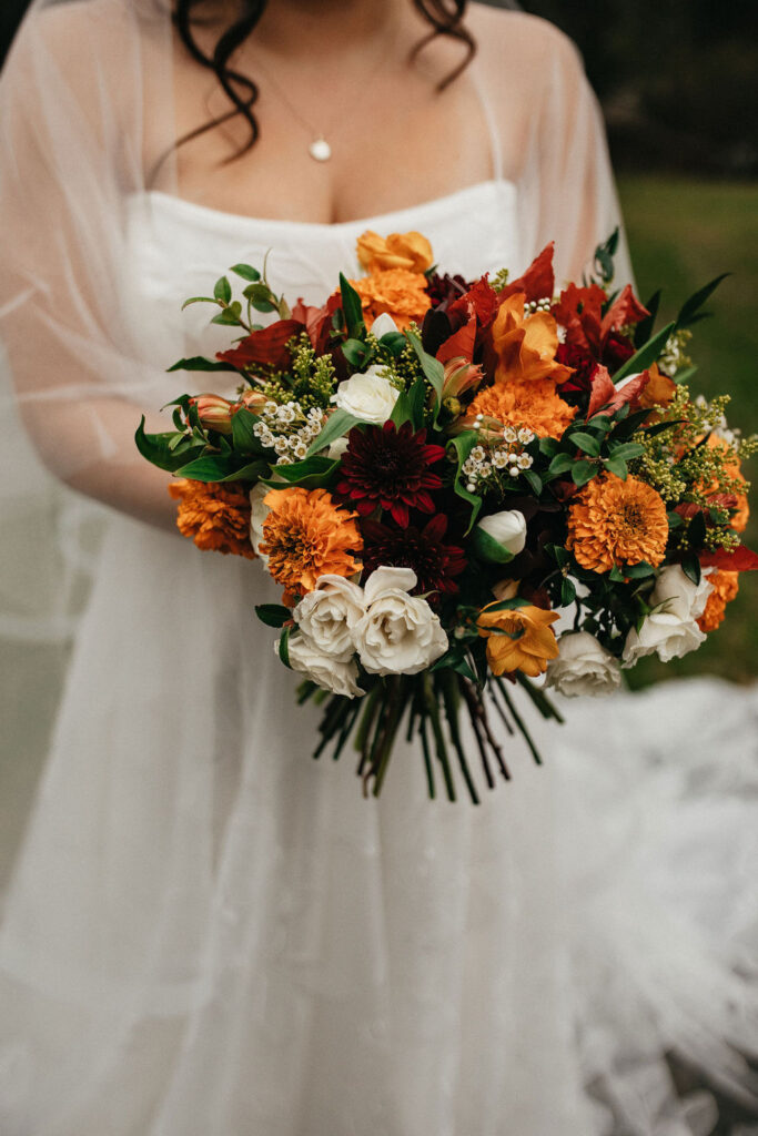A colorful winter wedding bouquet is photographed at kindred oaks georgetown
