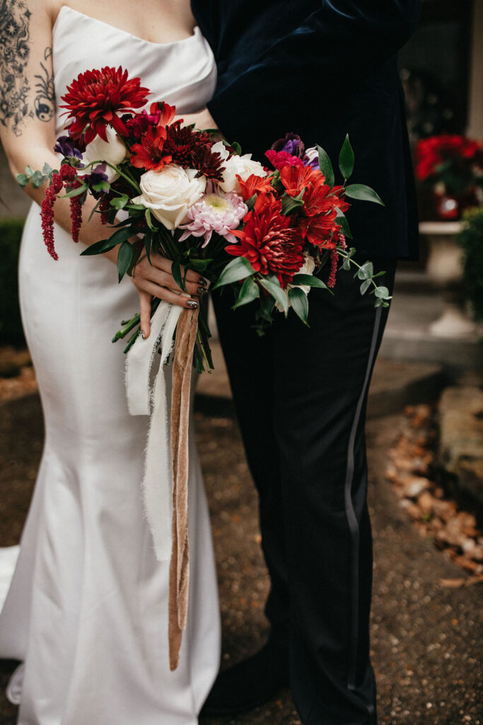 Bridal portrait taken at a wedding in Houston TX with a focus on the red bouquet