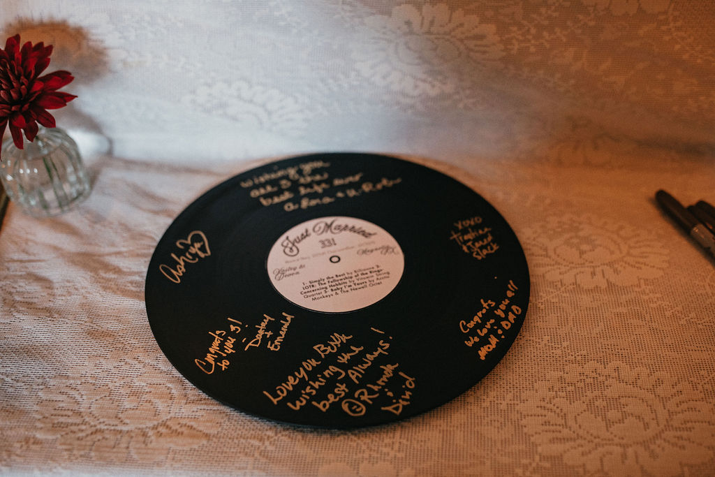 A vinyl record guestbook is shown at a Houston wedding 