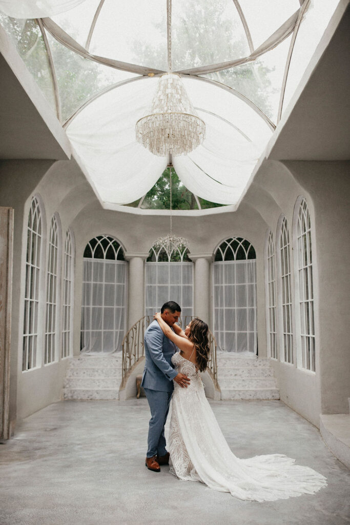 Newlyweds pose for a photo at their Rosewood Atelier wedding in Houston 