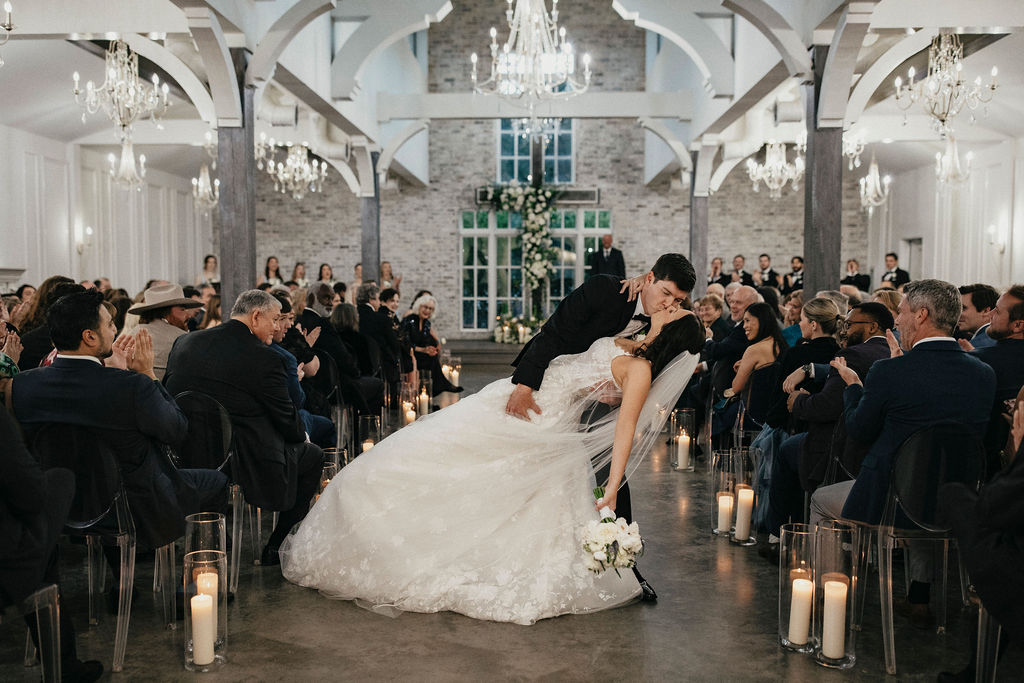 A bride and groom celebrate at The Peach Orchard, one of many indoor Houston wedding venues with a luxurious aesthetic