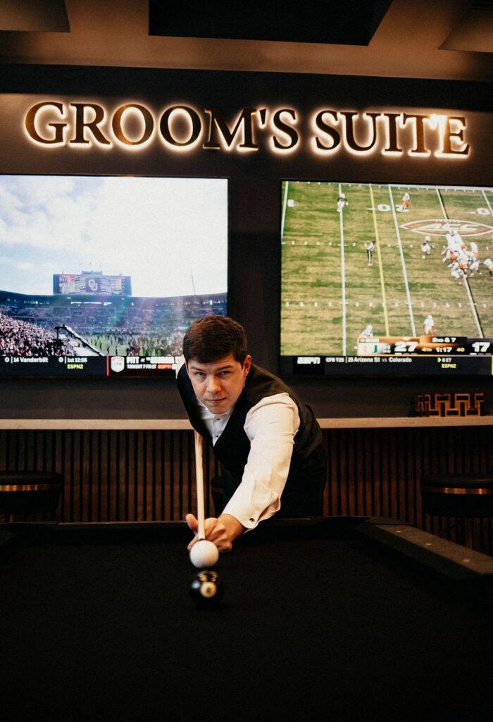 A groom is photographed in the groom suite at the peach orchard venue