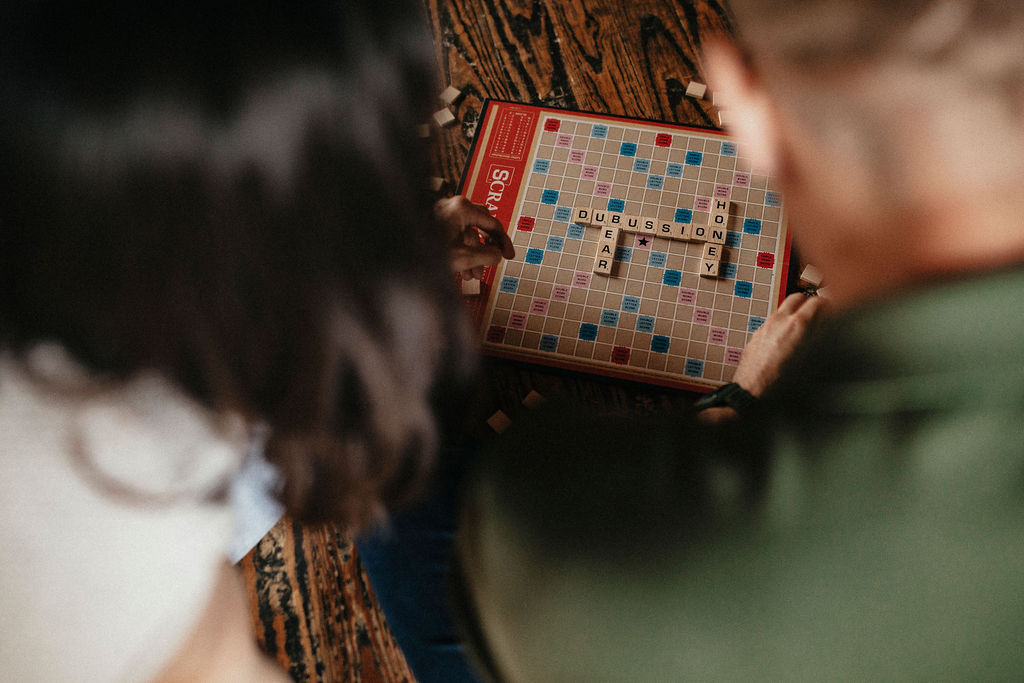 A couple incorporates their love of board games with Scrabble in this image taken by a Houston engagement photographer 