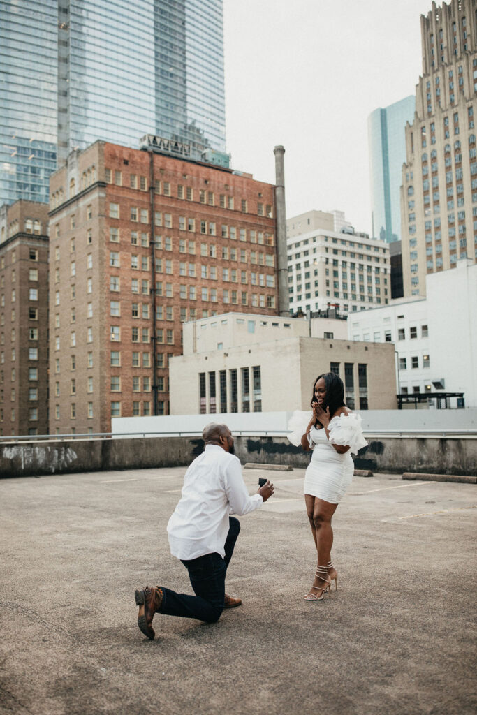 A Houston man proposes in downtown Houston in a photo captured by Houston engagement photographer 