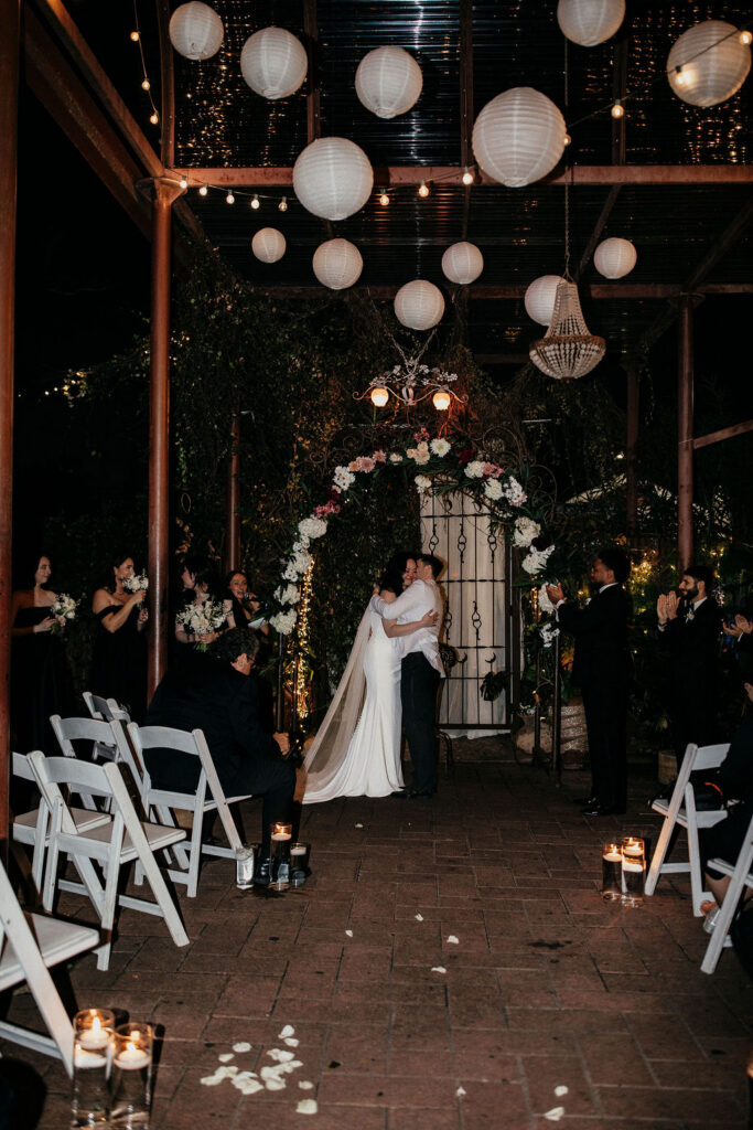 Newlyweds share a kiss at their avant garden houston wedding ceremony. 