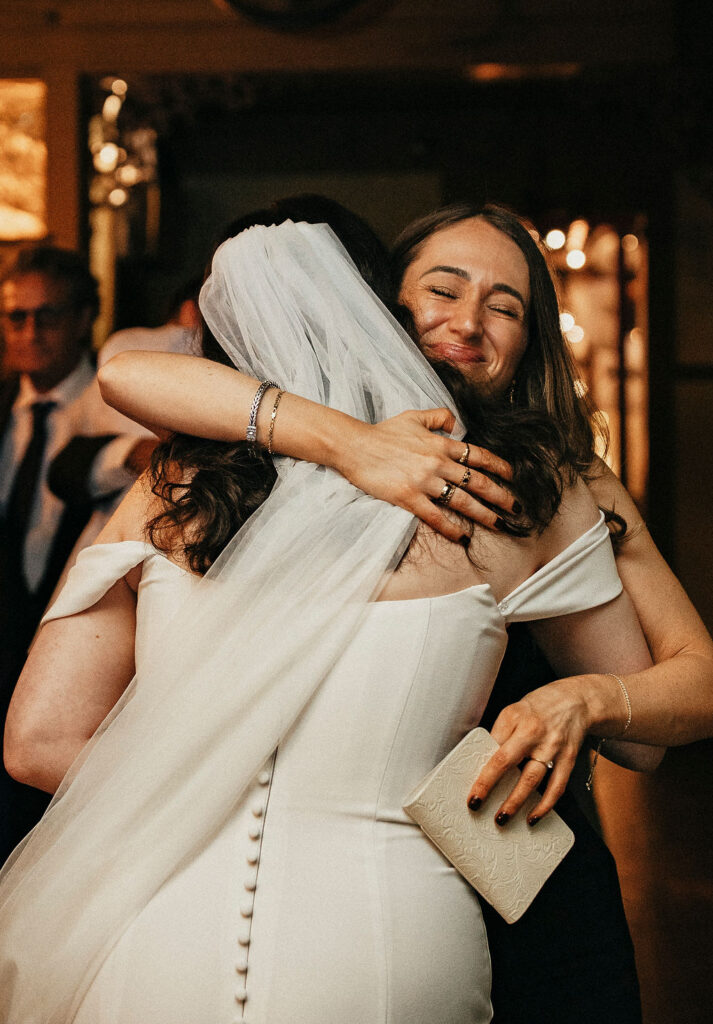 A bride hugs a guest following her avant garden houston wedding. 