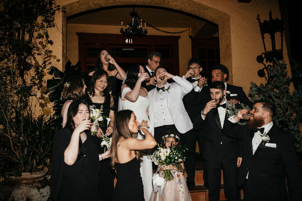 Newlyweds share a celebratory shot with their wedding party following their avant garden houston wedding. 