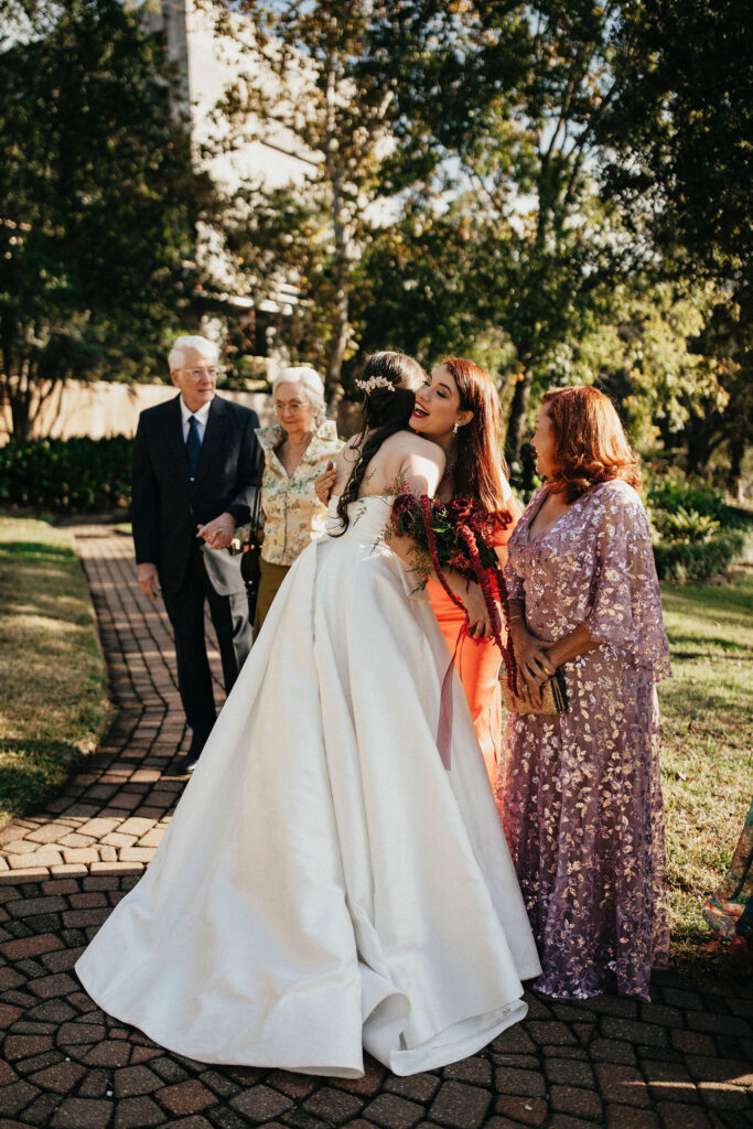 A bride hugs guests at her Houston elopement. 