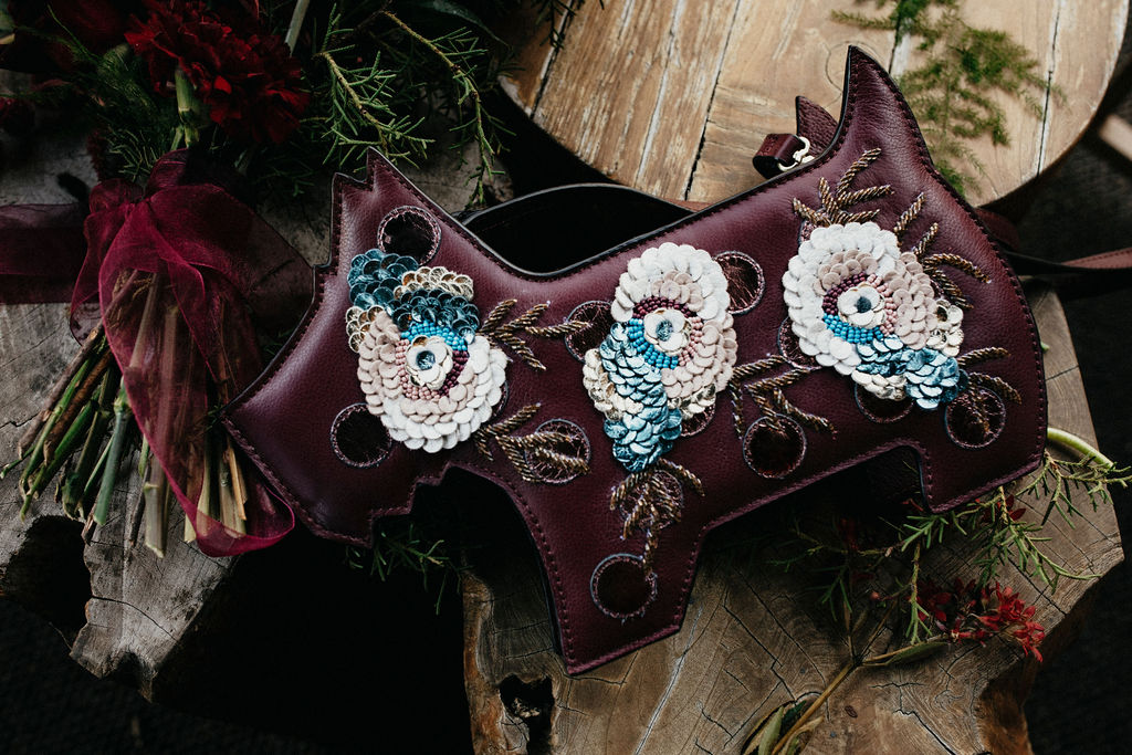 Wedding details including a custom handbag and a winter bridal bouquet is photographed at a Houston elopement ceremony. 