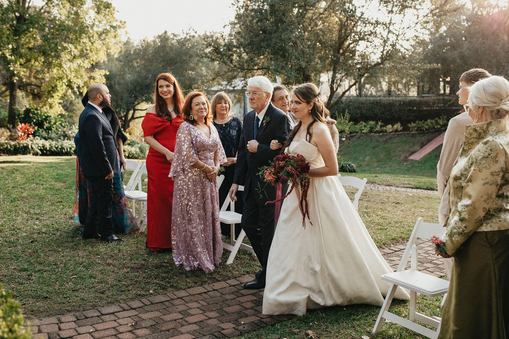 A bride walks down the aisle on her father's arm at her Houston elopement. 