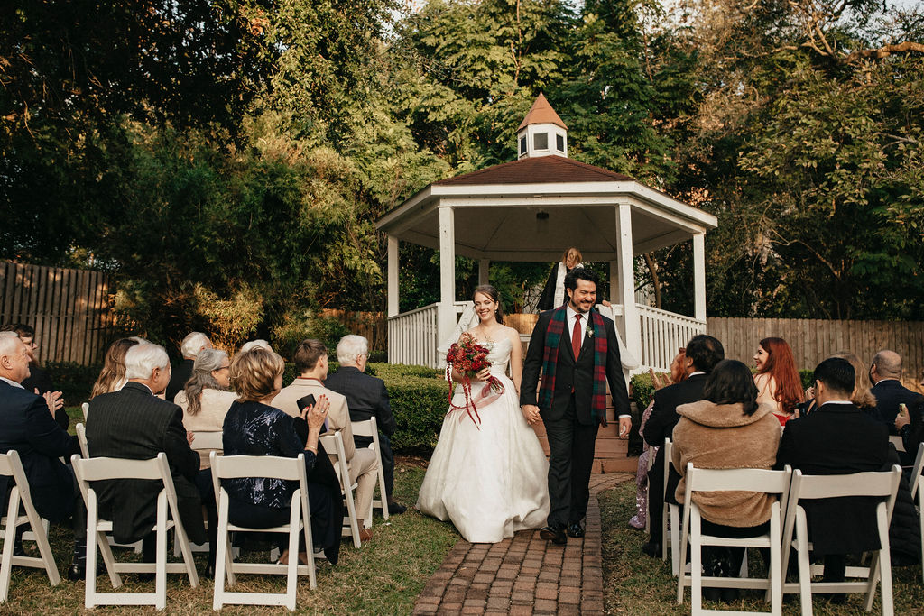 A Texas couple walk down the aisle after their Houston elopement at Brenner's Bayou. 