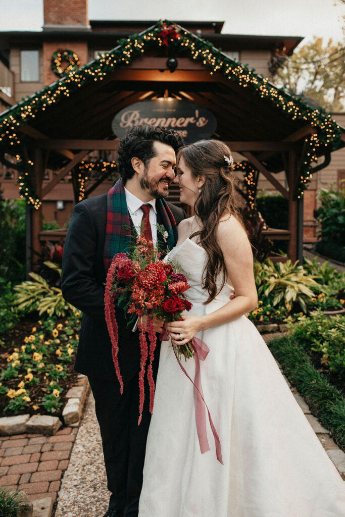Newlyweds pose for a bridal portrait at the front entrance of Brenner's on the Bayou where they hosted their winter Houston elopement. 