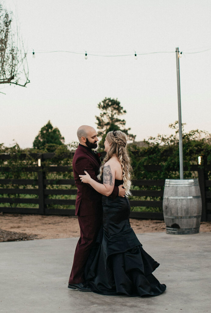 Newlyweds share a first dance at their Texas ranch wedding reception.